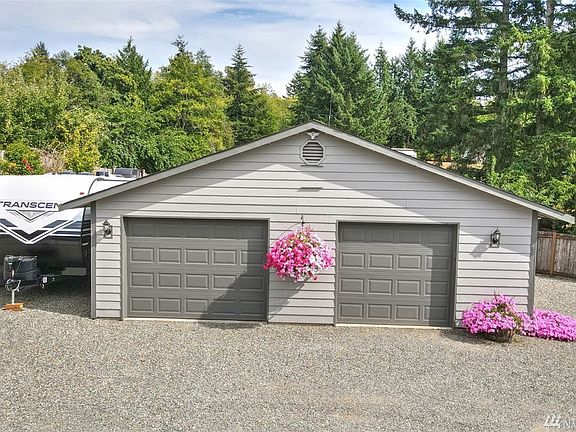The garage is approximately 960 square feet and the garage doors are newer and have garage door openers.  It is also freshly painted and has a rear man door with patio.  There's also a huge amount of firewood in the back that will stay!