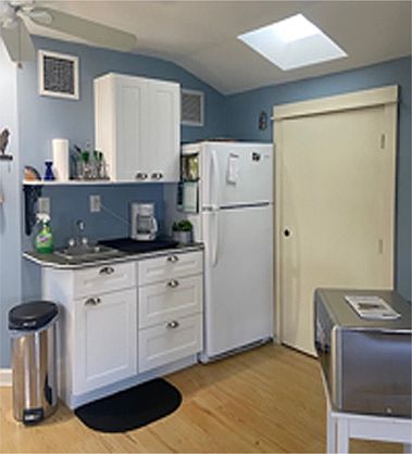 Kitchenette, induction 2 burner cooktop, convection oven/microwave. Door to walk in closet.