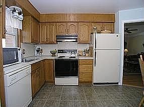 Plenty of Newer Oak Cupboards and Counter Space Hidden fold out pantry