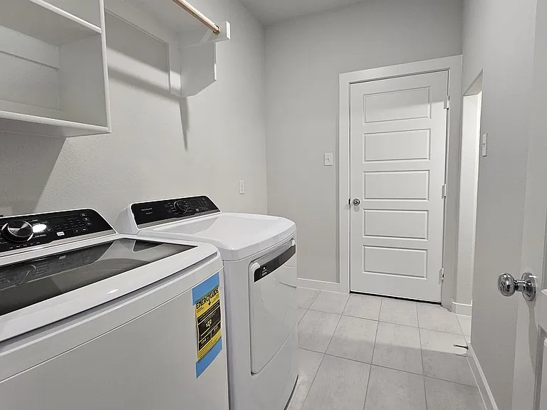Convenient mudroom and laundry area with extra storage space. Already installed brand new washer and dryer.