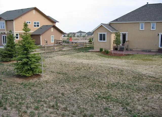 Rear yard, now fully fenced for pets. All exterior photos were taken in winter.
