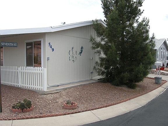 carport to the right of tree