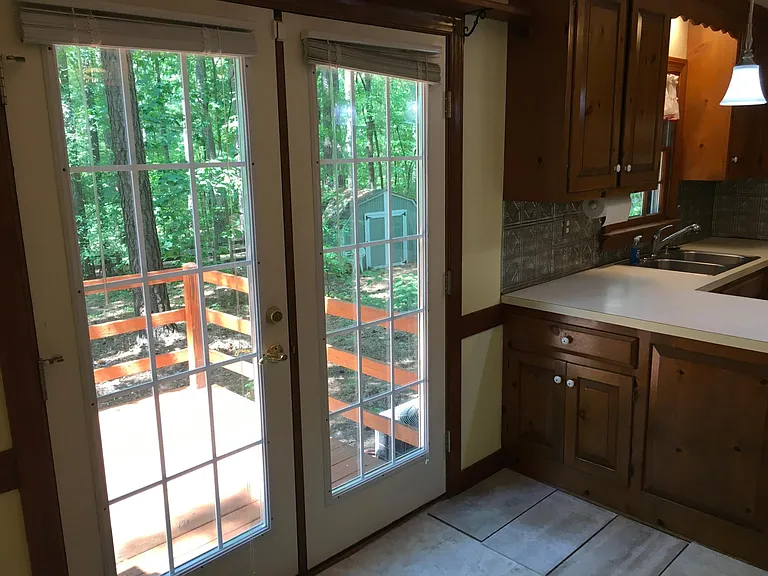 Breakfast area. Deck and large Shed visible through the French doors.
