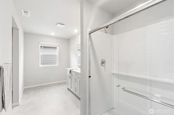 Master bathroom with walk-in closet and walk-in shower.