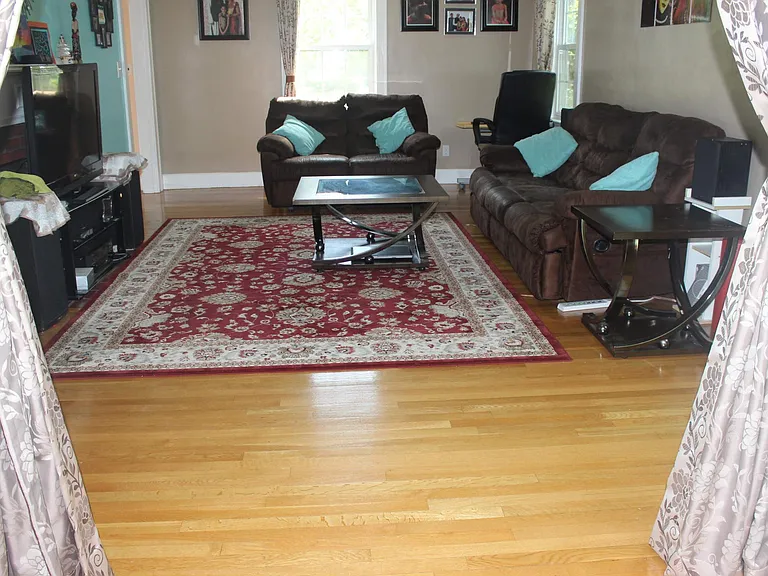 Living room view from Sun room. left hand wall has wood burning fireplace.