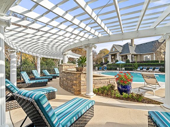 Spacious poolside sundeck with lounge chairs at Hawthorne at the Carlyle in Greenville, SC