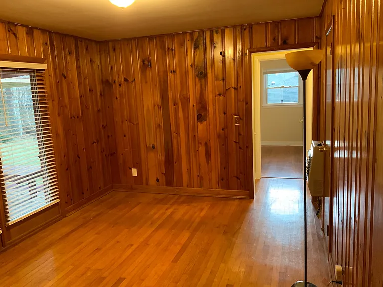 Back family room with a view to deck on left and view into the 2nd bedroom