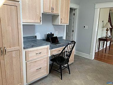 Kitchen work space, living room and stairs on right.