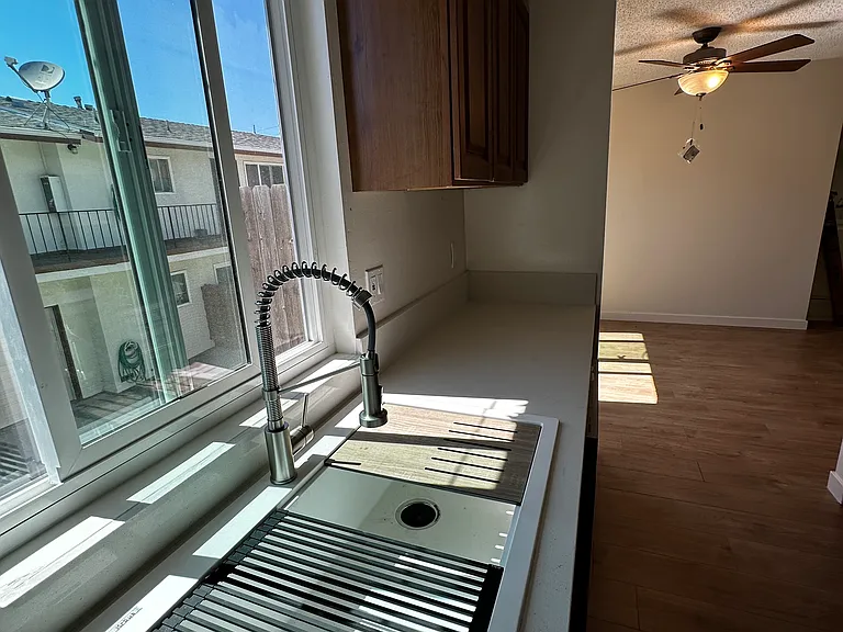 Kitchen View of New Sink/Faucet, looking towards Dining Room, with View. (New Installed Window Shades not Shown)