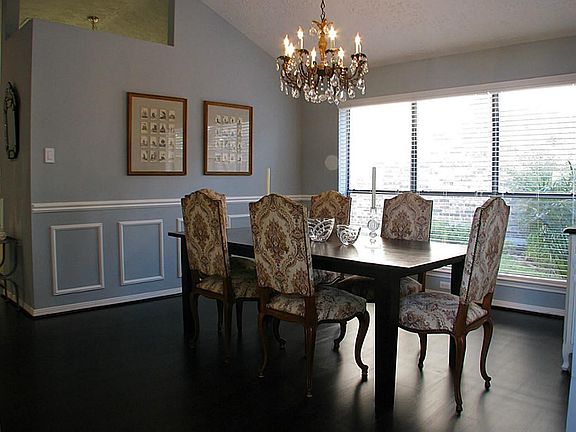 The dining room has views of the lovely gardens in the side yard.
