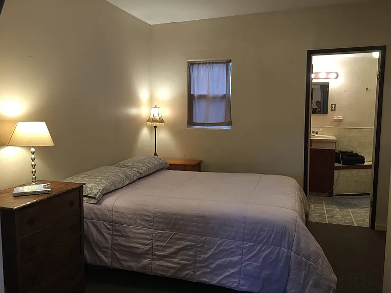 Through the archway is your bedroom, big enough for a Queen sized be and a dresser
