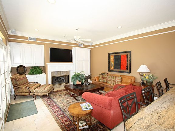 The den has doors leading to the pool, gas fireplace, surround sound, and buil