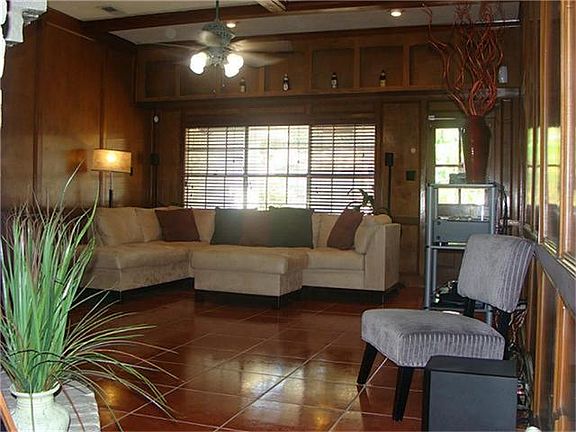 Large open living area, overlooking the pool with tile floor