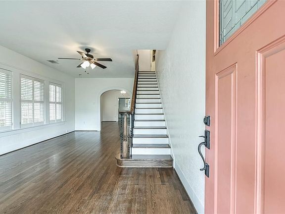 Upon entry to the home appreciate the abundance of natural light and arch doorway that leads to the dining room.