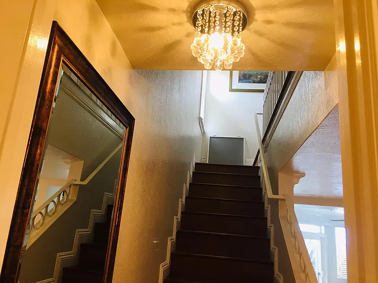 stairs with window for views of Huntington Beach Pier, white waters, surfers etc...