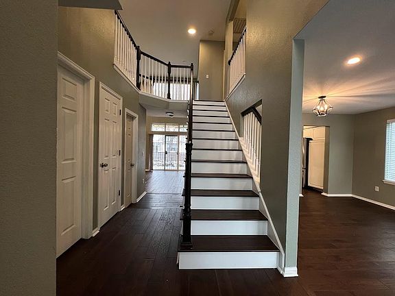 Entry, stairs, living/dinning to the right and hallway to family/great room.