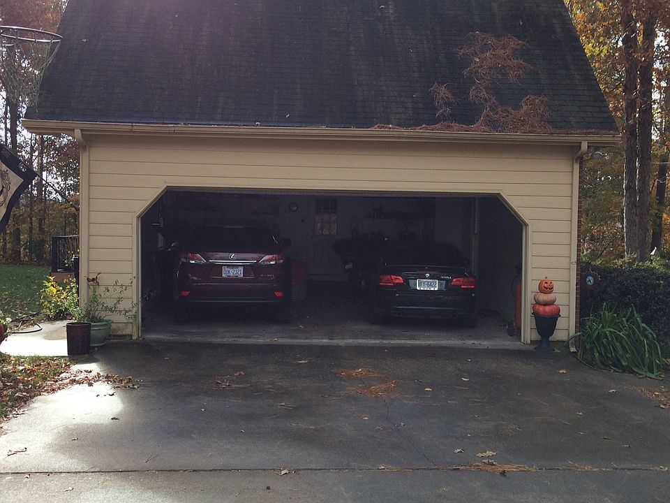 Large two car garage with work bench and shelves. View is fr