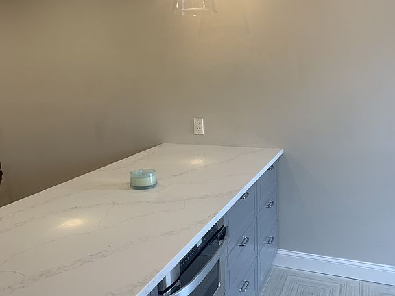 There alenty of drawers and storage, a microwave drawer, and a large countertop with room for four barstools. Perfect for entertaining, cooking, working from home, etc.