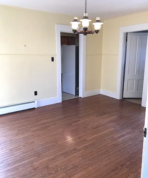 Living room from front door entrance. Door on left is to kitchen, whereas door on right is to the bathroom.