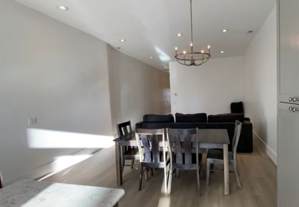 Living/dining area adjacent to kitchen and deck.