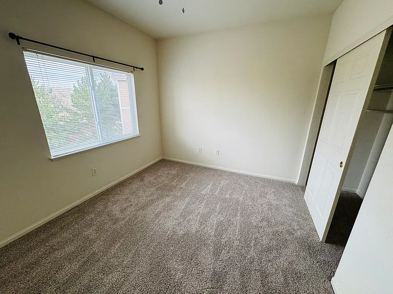 The second bedroom overlooks open space to the back with a bathroom and linen closet close by.