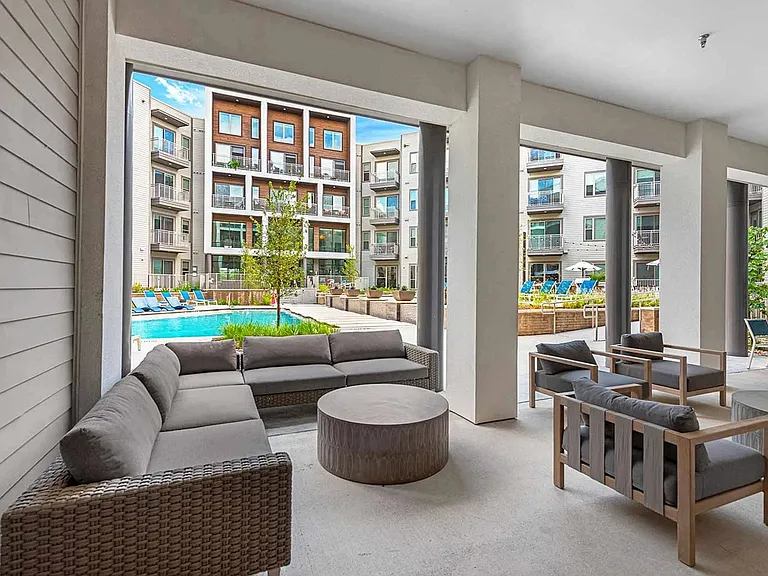 Outdoor entertainment space that's outfitted with a grilling station, shaded gathering terrace, and abundant seating.