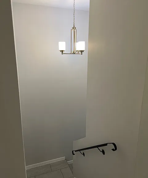 Stairwell, Brand New Tile and Grout, New Baseboard Molding, Handrails, Stairwell Chandelier Light.