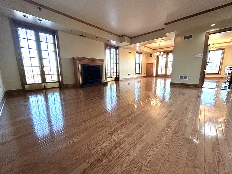 Large open living space w/ operatable gas fire place, Juliet balconies, high ceilings and beautiful hardwood flooring.