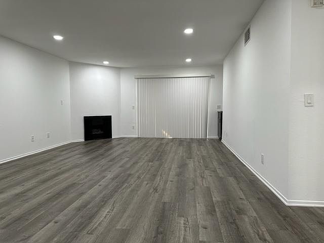 Large living room with recessed lighting and fireplace.