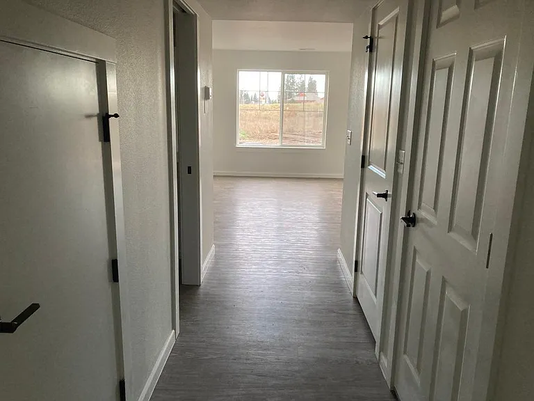Come on in! Hallway leads to half bath and living room, dining room and kitchen area.