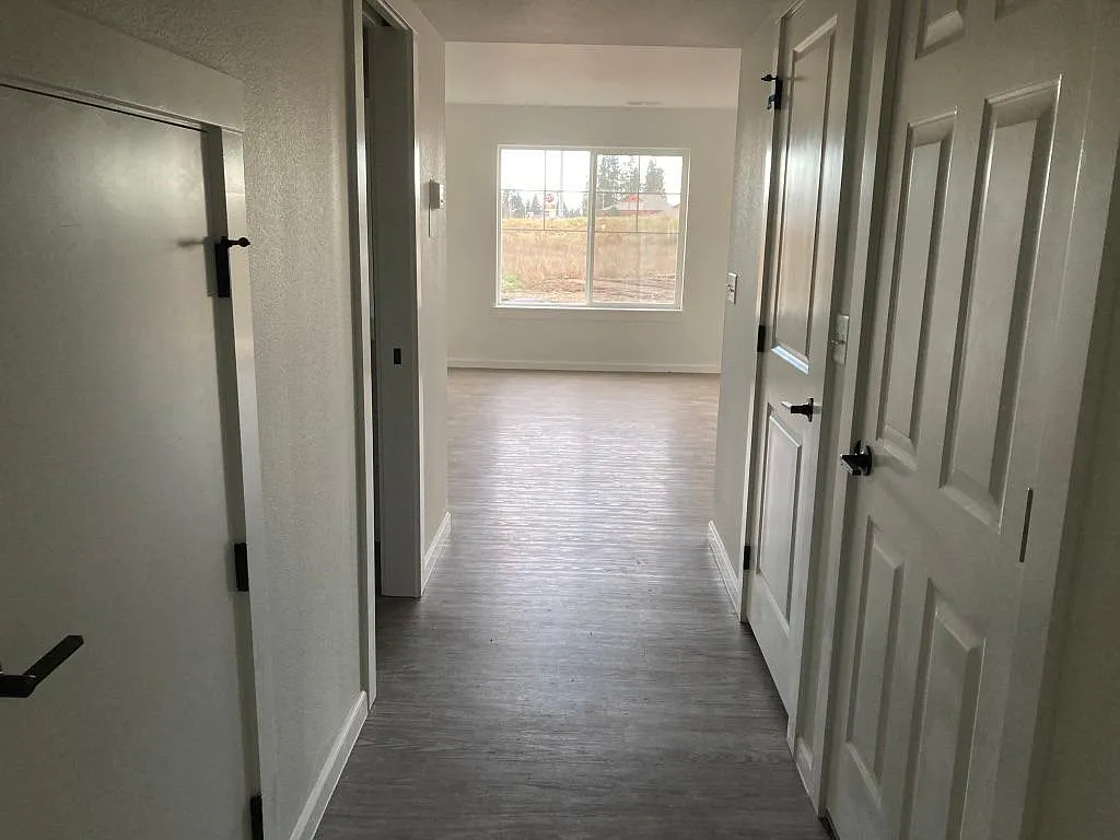 Come on in! Hallway leads to half bath and living room, dining room and kitchen area. - 7128 W Heritage St