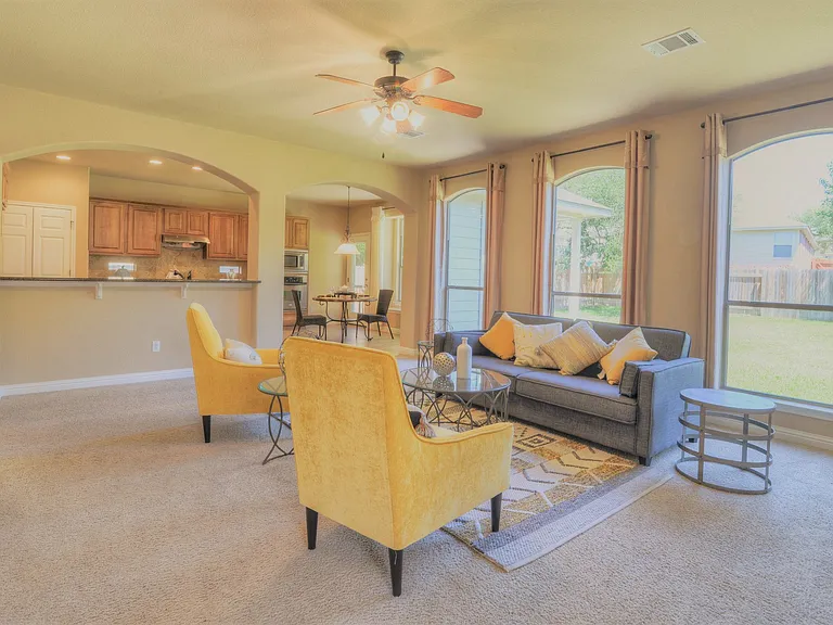 Living room has gorgeous windows looking into the backyard