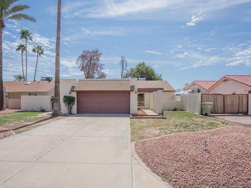 Front of home, driveway offers plenty of space for up to 4 cars and garage offers washer/dryer hookup, plenty of space for stora