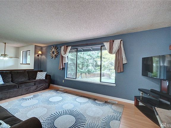 Enter the home to a spacious living room with big windows to let in all the natural light.