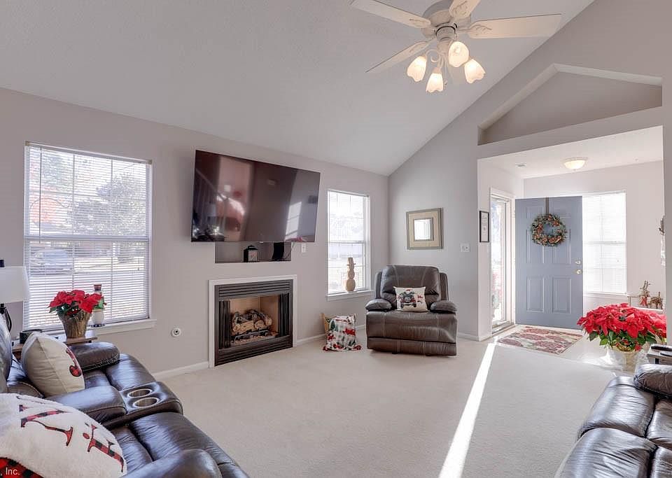 Spacious living area with abundance of natural light that radiates the entire room.  Wall mounted 70 " TV ( just a year old) conveys with this beautiful home :))