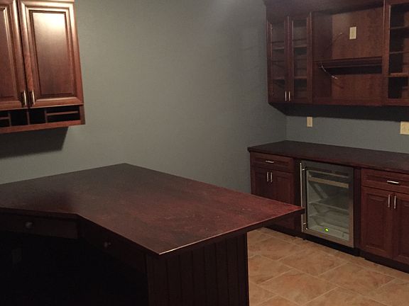 First level- home office with desk and bar.