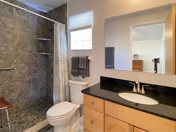 Bathroom with new tile, fixtures and granite countertop. Glass block windows for natural lighting. Room is vented.