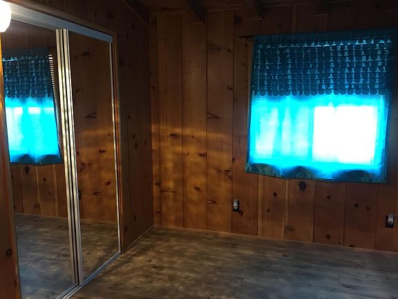 Back bedroom w/ mirrored closet doors