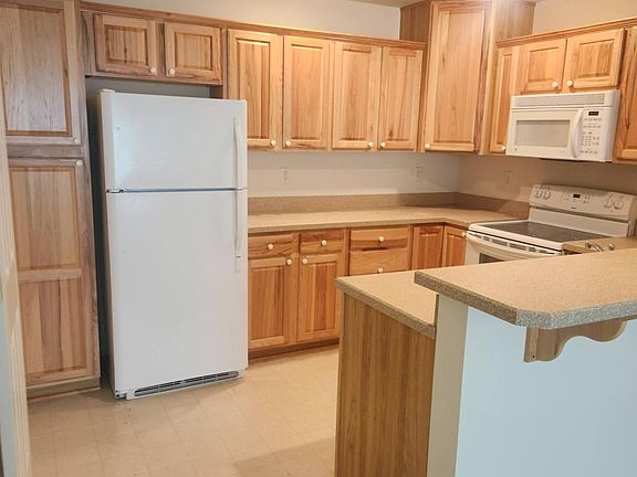 Kitchen with lots of storage/cabinets and counter with room for stools.