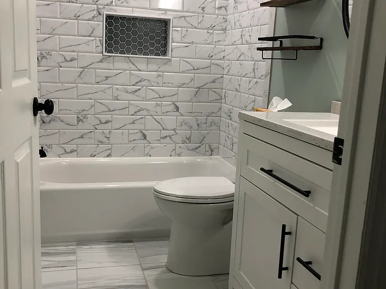 updated hallway bathroom with skirted toilet