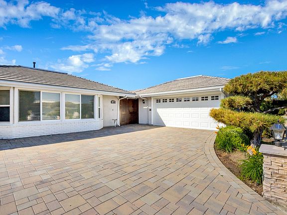 Gorgeous paved driveway and tastefully landscaped front yard