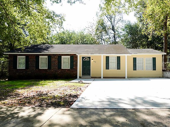 Front of house with new exterior paint and with newly seeded front yard
