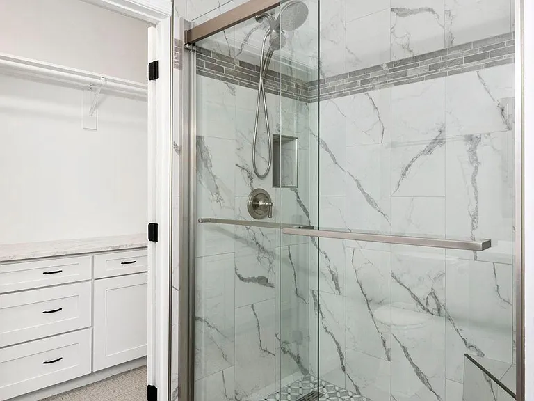 Main bathroom shower with magnetic Moen shower head water dispenser
