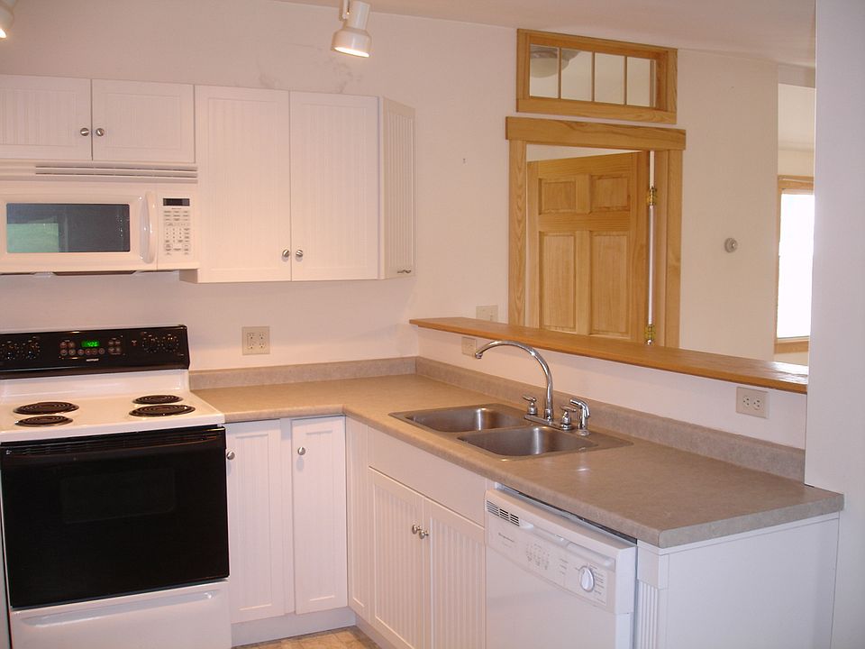 Partial view of the kitchen with bathroom door at right