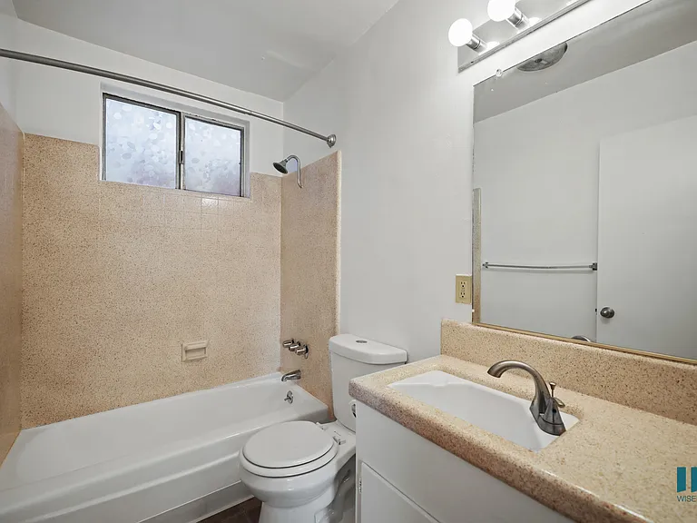 Bathroom with Shower Bath, Window, and Vanity Cabinet Storage