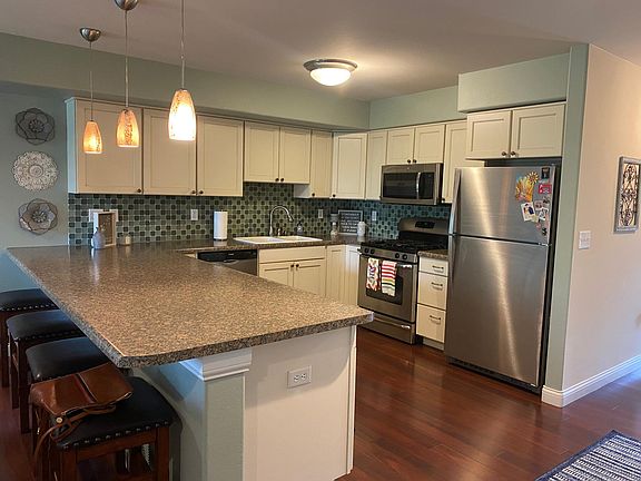 kitchen connected to living room, gas range, fisher & paykel dishwasher,