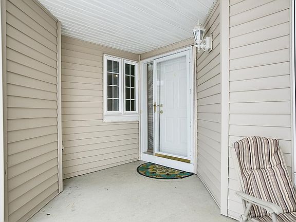 The front porch has room for a couple chairs to enjoy Minnesota seasons!