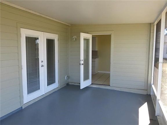 Lanai with updated french doors with built in blinds.