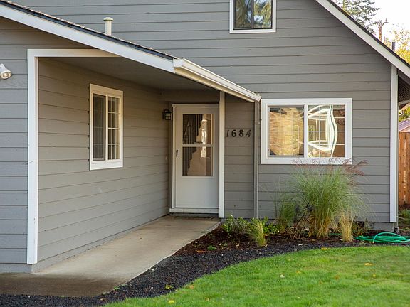 Front door/entrance, with kitchen window overlooking front yard