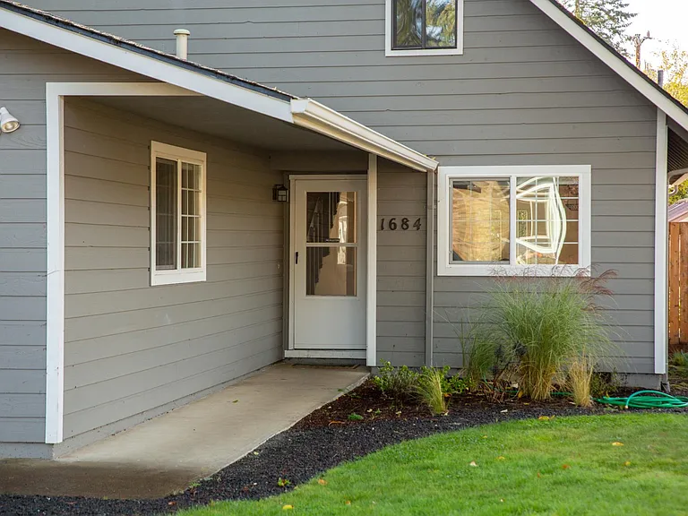 Front door/entrance, with kitchen window overlooking front yard